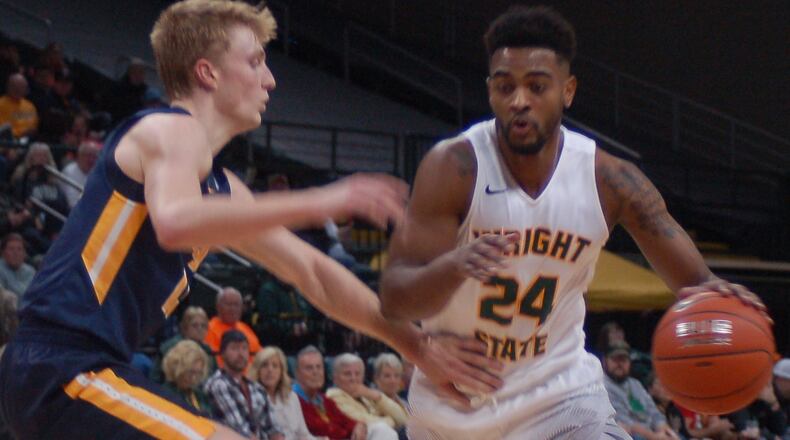 Wright State’s Mark Alstork goes past Toledo’s Jaelan Sanford during the first half of their contest Saturday night at the Nutter Center. Alstork finished with a game-high 39 points. JOHN CUMMINGS/CONTRIBUTED