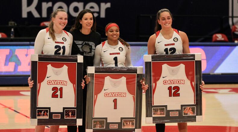 Dayton coach Shauna Green poses for a photo with seniors Erin Whalen, Araion Bradshaw and Jenna Giacone after a game against Saint Louis on Saturday, Feb. 20, 2021, at UD Arena. David Jablonski/Staff