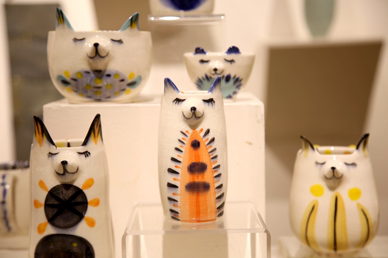 The whimsical faces of cats are created in ceramic tea cups, mugs, vases and bowls by artist Katie Swartz.  Prices range from $22-$65. LISA POWELL / STAFF