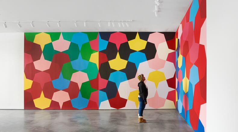 A visitor views Odili Donald Odita's mural at The Contemporary in Dayton. CONTRIBUTED