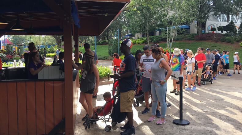 SeaWorld Orlando visitors line up for free beer, a summertime promotion at the theme park. Guests can get up to two complimentary 7-ounce pours at a specific bar near Shamu Stadium. (Dewayne Bevil/Orlando Sentinel/TNS)