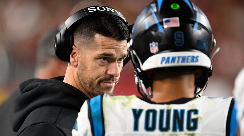 Carolina Panthers head coach Dave Canales talks with quarterback Bryce Young during the first half an NFL football game against the San Francisco 49ers, Monday, Nov. 24, 2025, in Santa Clara, Calif. (AP Photo/Eakin Howard)