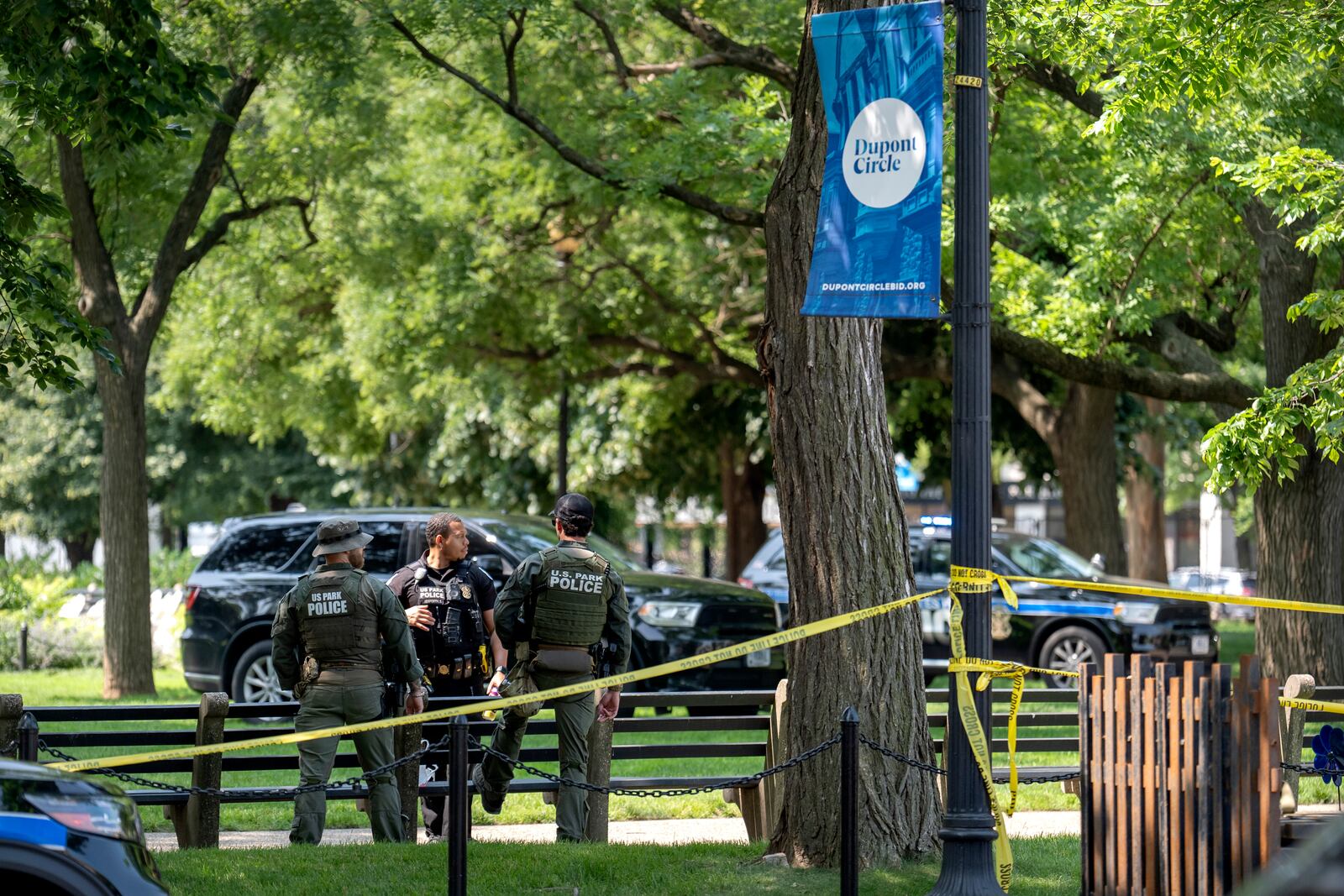 U.S. Park Police stand by as workers put up fencing around Dupont Circle ahead of the World Pride Parade, Friday, June 6, 2025, in Washington. (AP Photo/Mark Schiefelbein)
