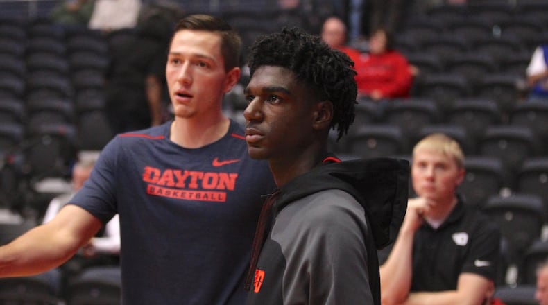 Kira Lewis, right, talks with Dayton's Ryan Mikesell before a game against Ball State on Friday, Nov. 10, 2017, at UD Arena.