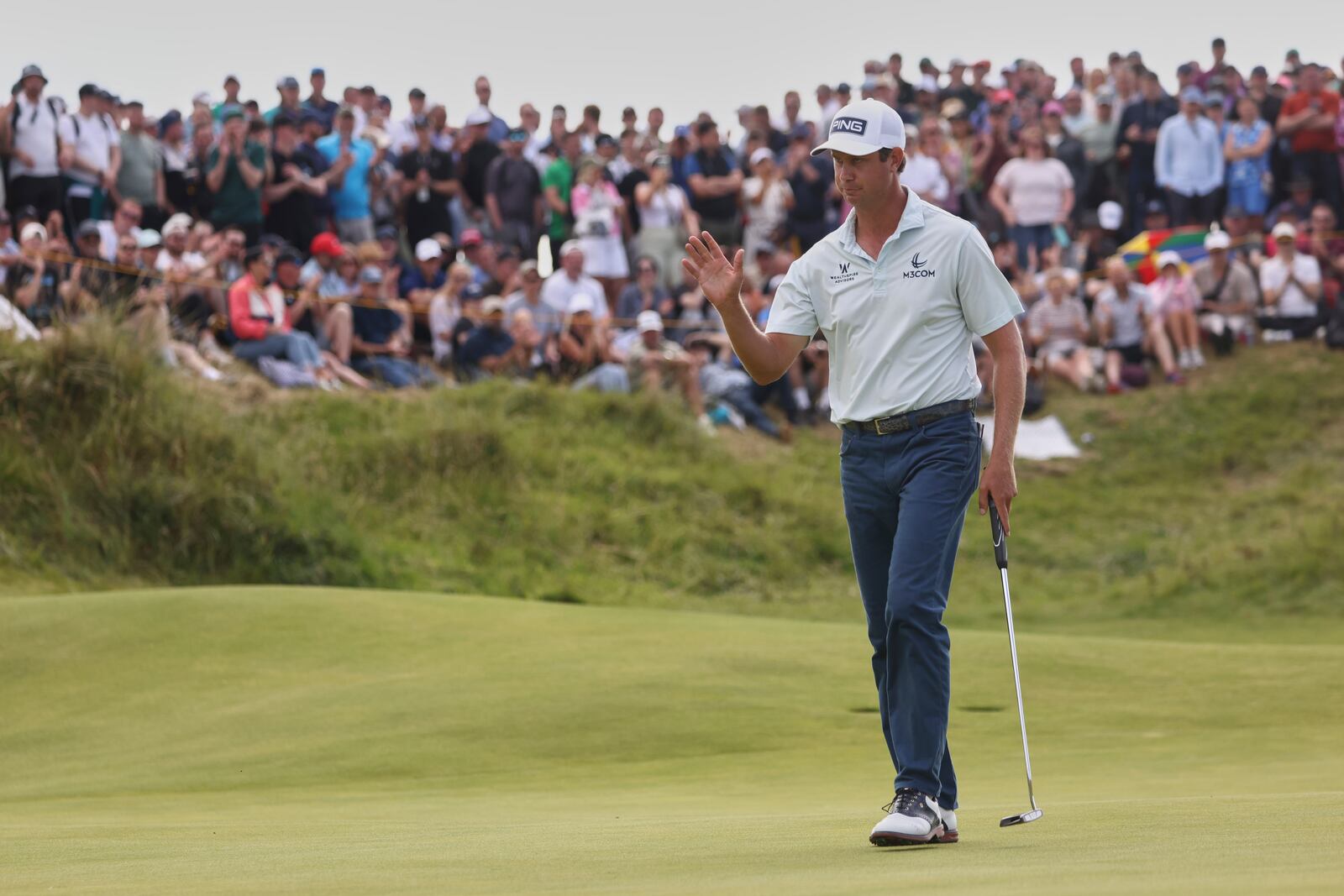 Harris English of the United States acknowledges the crowd on the 8th green during the final round of the British Open golf championship at the Royal Portrush Golf Club, Northern Ireland, Sunday, July 20, 2025. (AP Photo/Peter Morrison)