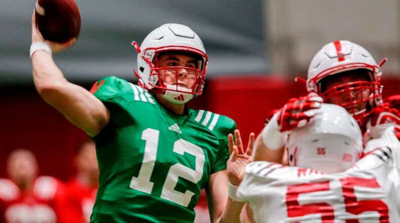 FILE - In this April 3, 2018, file photo, Nebraska quarterback Patrick O'Brien (12) throws during spring training in Lincoln, Neb. Spring practice is just past the midway point at Nebraska, and new coach Scott Frost is beginning to flesh out a quarterback pecking order. (AP Photo/Nati Harnik, File)