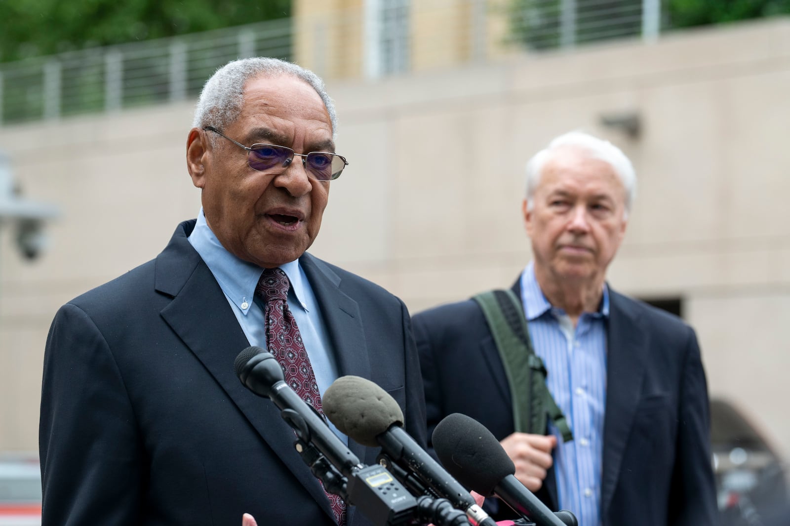 U.S. Institute of Peace (USIP) acting President George Moose, left, and USIP acting counsel George Foote take part in a newss conference outside the Institute, Wednesday, May 21, 2025 in Washington. (AP Photo/Kevin Wolf)