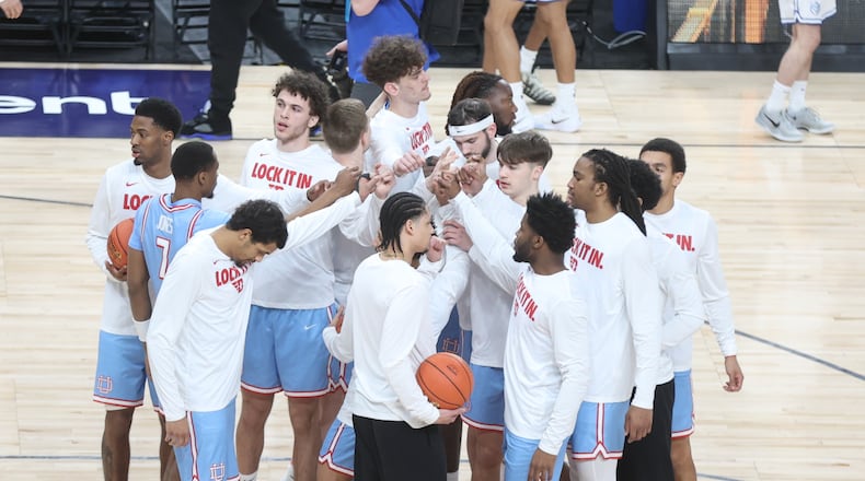 Dayton huddles before a game against Saint Louis in the semifinals of the Atlantic 10 Conference tournament on Saturday, March 14, 2026, at PPG Paints Arena in Pittsburgh. David Jablonski/Staff