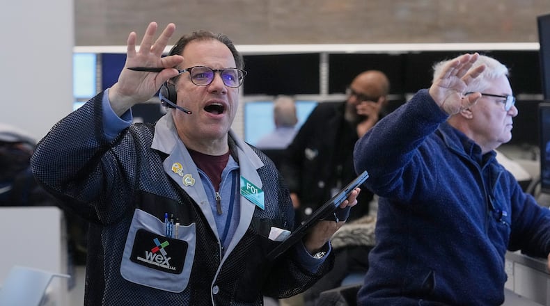 Anthony Spina, left, works with fellow options traders on the floor of the New York Stock Exchange, Wednesday, Jan. 28, 2026. (AP Photo/Richard Drew)