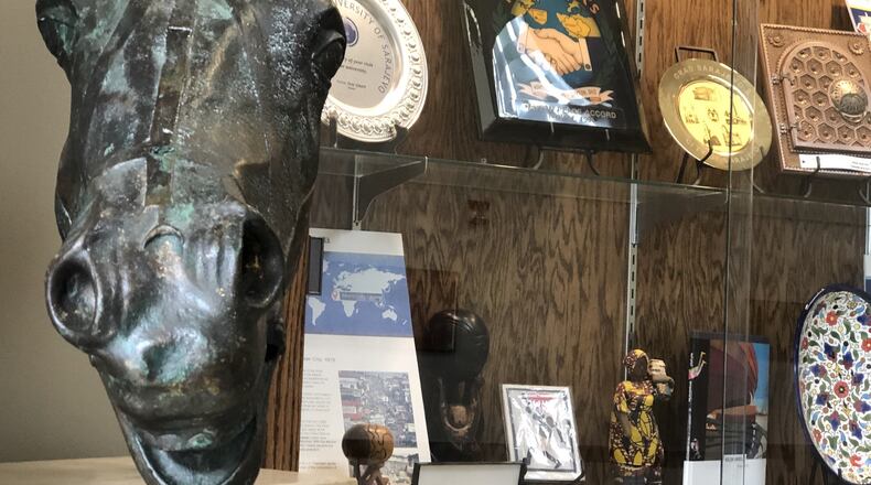 A display at Dayton City Hall features some items and gifts from Dayton’s sister cities. Dayton now has a fifth sister city: Rushmoor, a borough in the United Kingdom. CORNELIUS FROLIK / STAFF