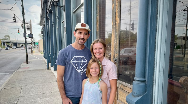Burgess and Jeanine Gow of 521 LLC have purchased the Dietz Block building on Wayne Avenue in Dayton. Pictured with the couple is their daughter, Kay. NATALIE JONES/STAFF