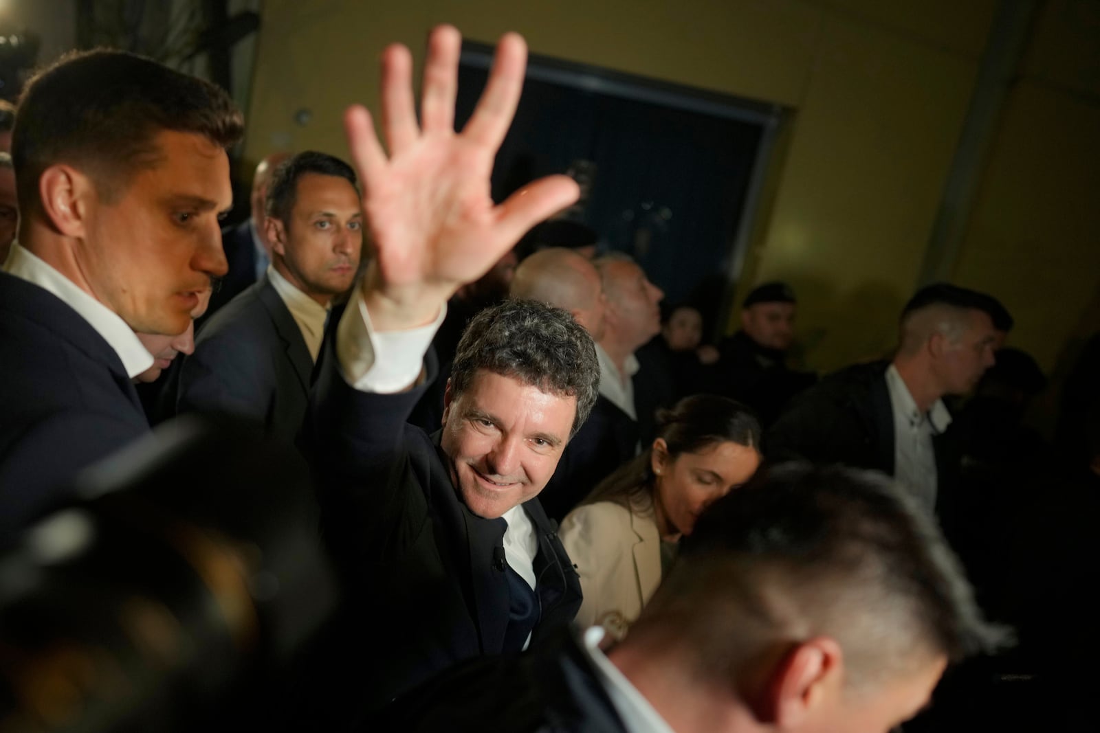 Presidential candidate Nicusor Dan waves to his supporters after polls closed for the second round of the country's presidential election redo in Bucharest, Romania, early Monday, May 19, 2025. (AP Photo/Vadim Ghirda)