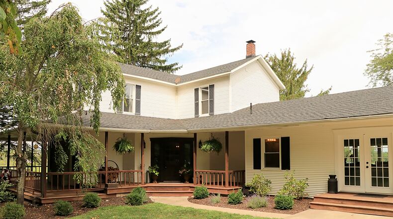 Sitting on just under an acre, this frame-and-vinyl homestead has about 3,790 sq. ft. of living space. The farmhouse has updated landscaping and a new garden shed. A wide, wrap-around covered porch starts at the diagonally set formal entry with side-lights. CONTRIBUTED PHOTO BY KATHY TYLER