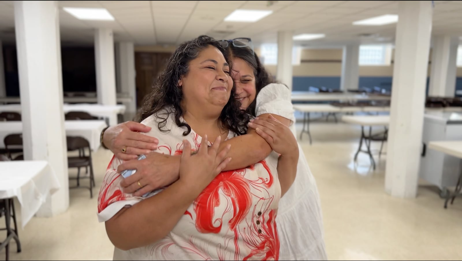 Virginia Rodriguez-Colon embraces Imelda Ayala Ramos at El Puente in Dayton. STAFF/DAVID SHERMAN