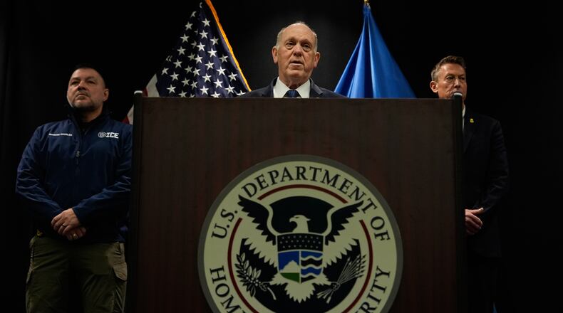 White House border czar Tom Homan holds a news conference as Marcos Charles and Rodney Scott, listen, at the Bishop Whipple Federal building on Thursday, Jan. 29, 2026 in Minneapolis. (AP Photo/Julia Demaree Nikhinson)