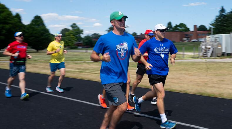 Airmen, civilians and family members run on a track along Skeel Avenue at Wright-Patterson Air Force Base on June 27. Many of the group’s members are preparing for the upcoming Air Force Marathon. U.S. AIR FORCE PHOTO/R.J. ORIEZ