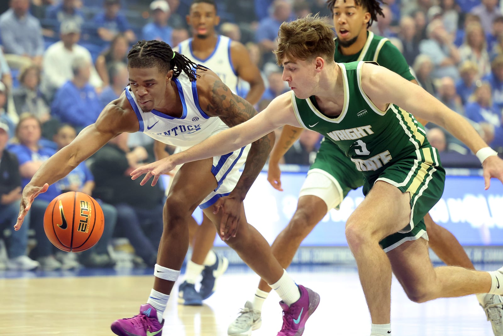 Kentucky's Otega Oweh, left, and Wright State's Alex Huibregtse (3) chase the ball during the first half of an NCAA college basketball game in Lexington, Ky., Monday, Nov. 4, 2024. (AP Photo/James Crisp)