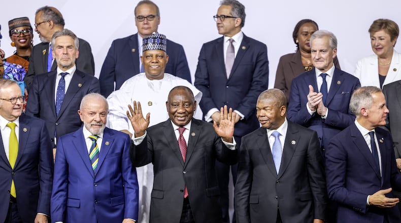 From left, front row, Australia's Prime Minister Anthony Albanese, Brazil's President Luiz Inacio Lula da Silva, South Africa's President Cyril Ramaphosa, President of Angola and Chairperson of the African Union Joao Lourenco and Canada's Prime Minister Mark Carney react as they pose a group photo, on the opening day of the G20 Leaders' Summit, in Johannesburg, South Africa, Saturday, Nov. 22, 2025. (Gianluigi Guercia/Pool Photo via AP)