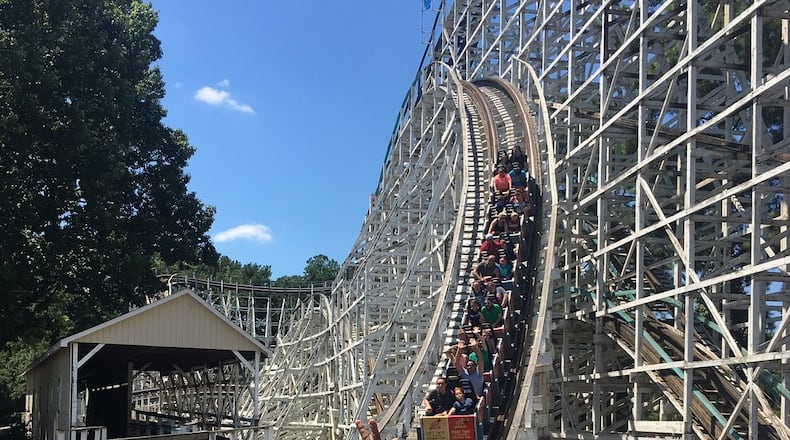 Parkgoers take one last ride on the Georgia Cyclone before it closed on Sunday, July 30. AJC/Greg Bluestein
