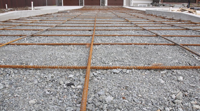 In many areas, pouring a new driveway while the weather s warm will allow it to dry before the freeze-thaw cycles start resulting in a flaw-free surface. (Dreamstime)