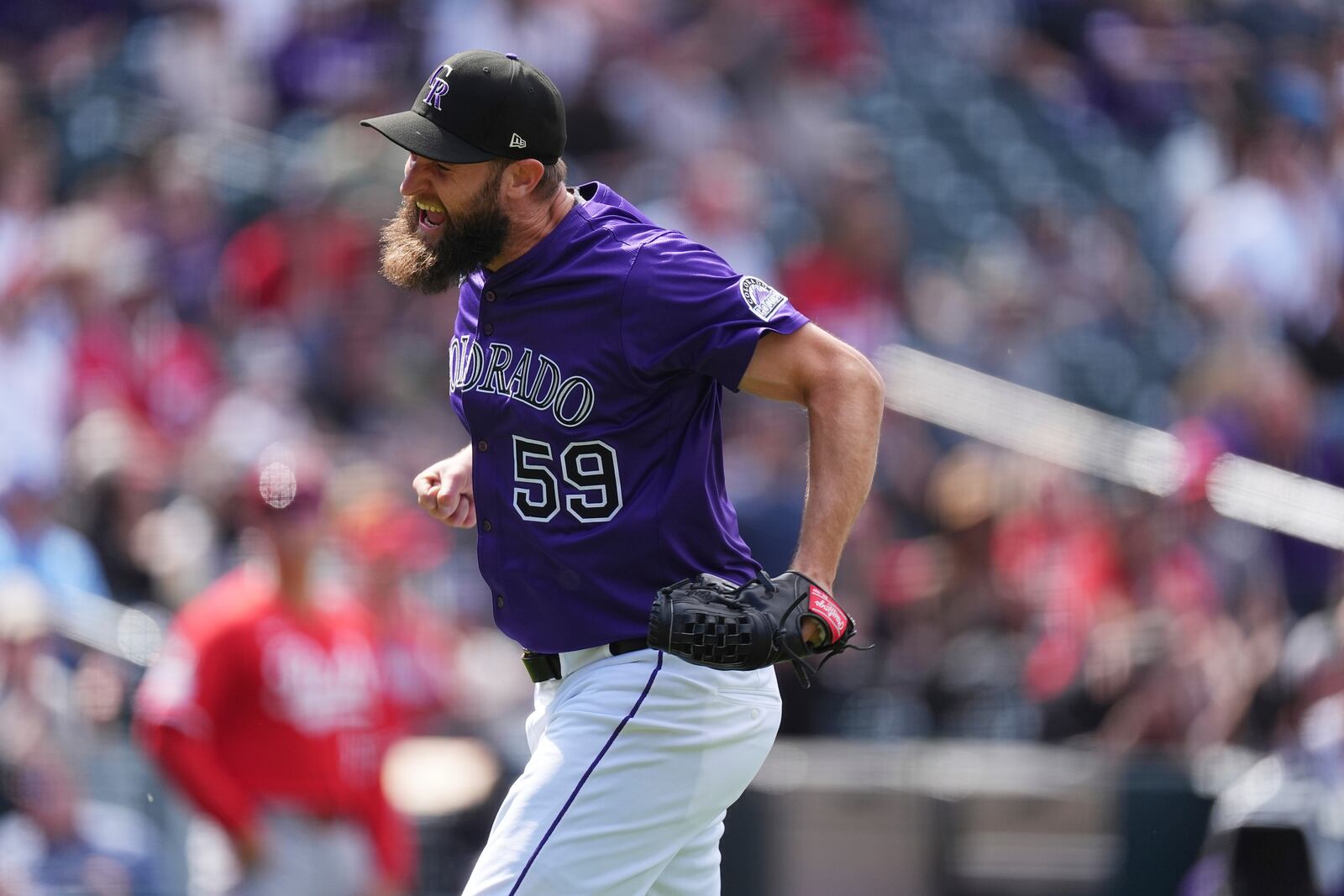 Colorado Rockies relief pitcher Jake Bird reacts after getting out of a bases-loaded jam by getting Cincinnati Reds' Gavin Lux to line out to end the top of the seventh inning of a baseball game Saturday, April 26, 2025, in Denver. (AP Photo/David Zalubowski)