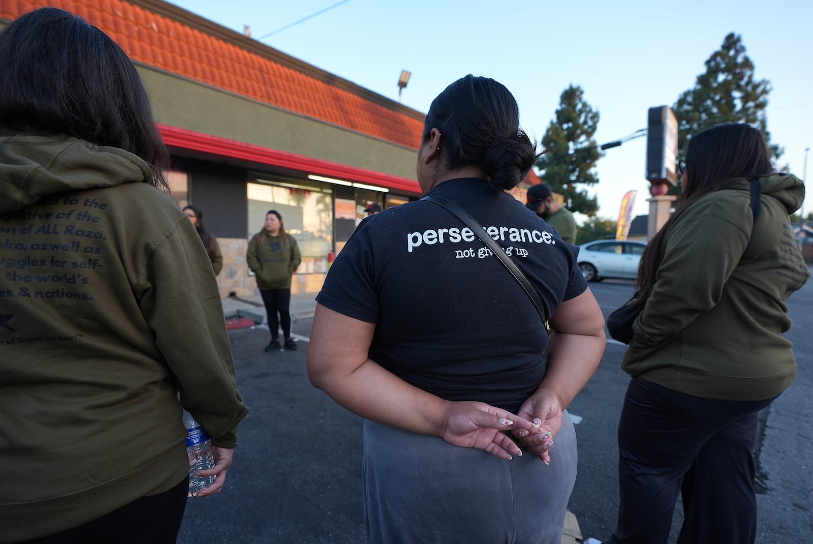 Members of the Union del Barrio, a grassroots political organization, gather to help alert people of the possible presence of ICE enforcement agents to people living in Los Angeles, Monday, June 16, 2025. (AP Photo/Damian Dovarganes)