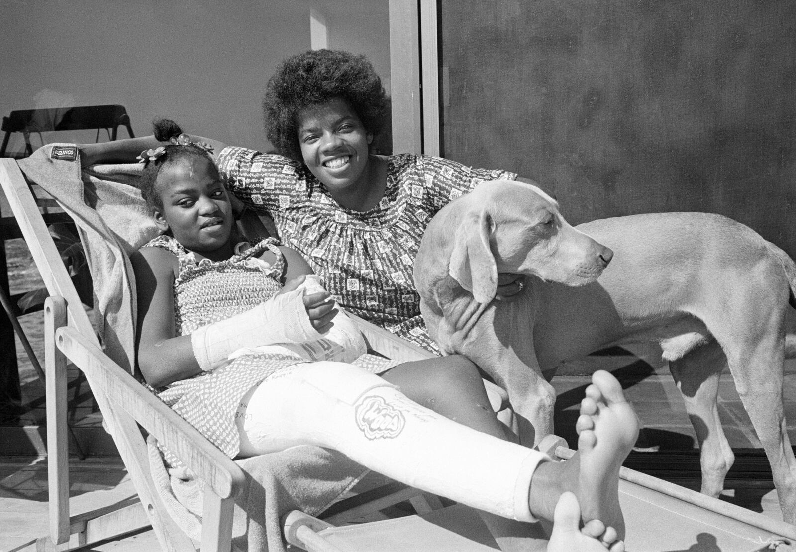 FILE - Danielle Spencer, left, and Cheryl Pelt rest at home in Malibu, Calif. after Spencer's release from Santa Monica Hospital on Friday, Sept. 16, 1977. (AP Photo/Nick Ut, File)