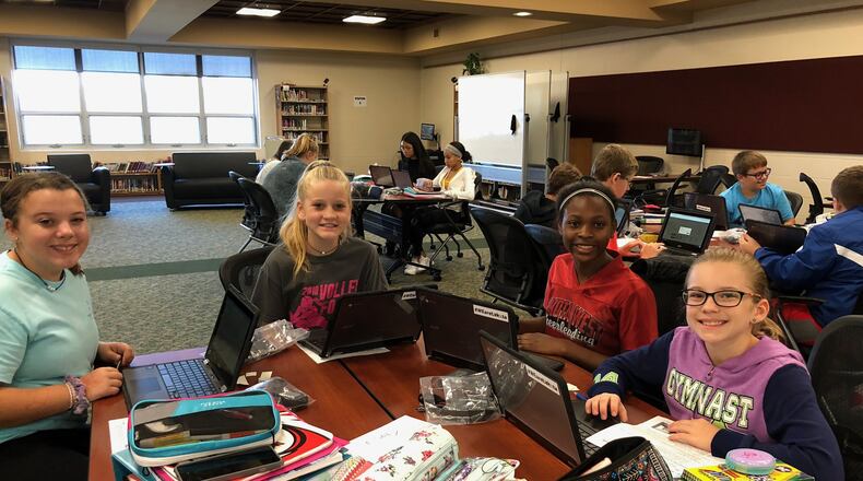 Students at Lakota Plains Junior School in Liberty Township are all smiles after receiving their Chromebooks as part of a historic pilot program to enhance student learning through the digital devices.