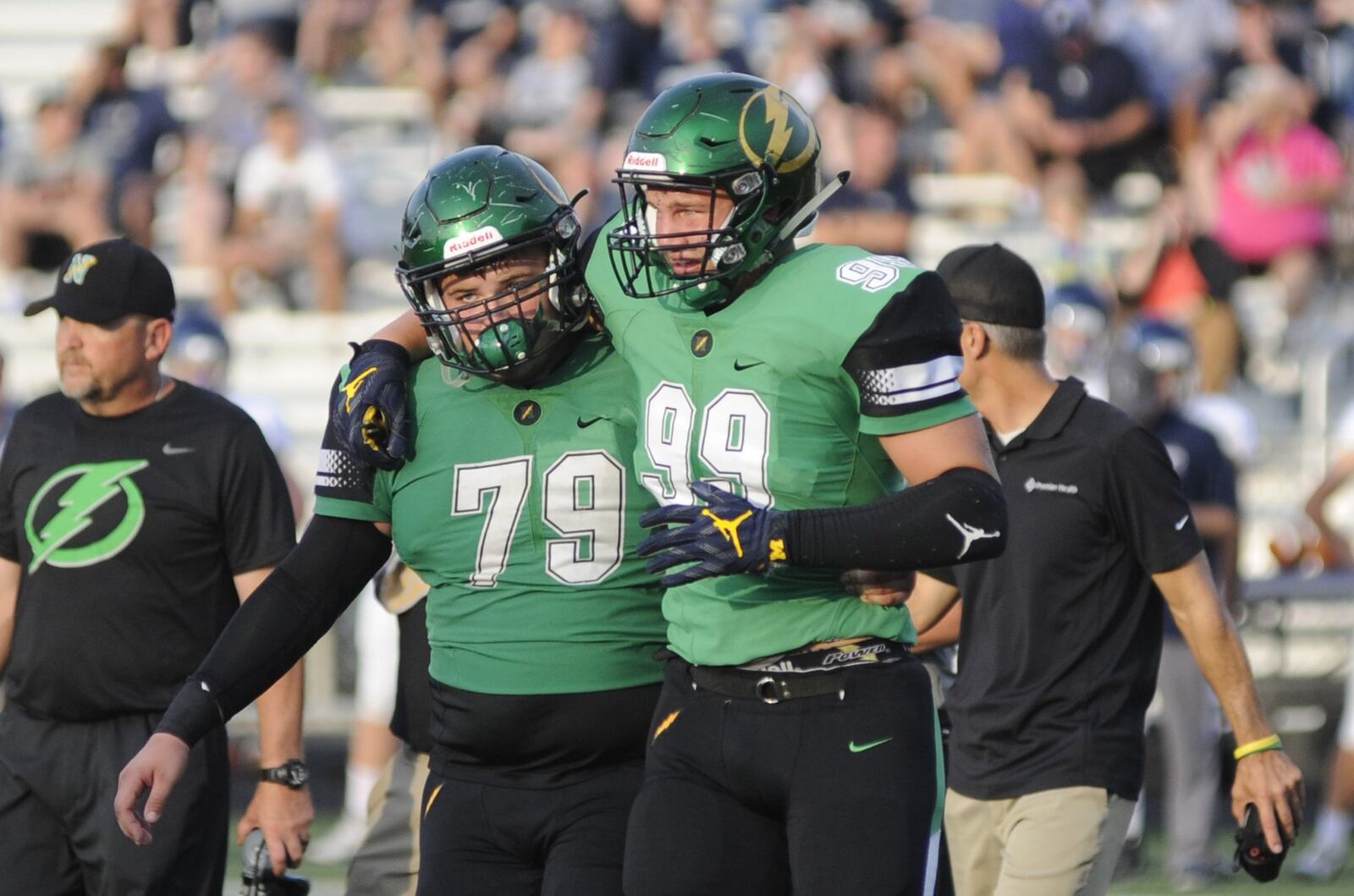 Northmont senior Gabe Newburg (right) is helped off the field by teammate David Weherley after injuring an ankle. Northmont defeated visiting Fairmont 24-21 in a Week 2 high school football game that was suspended on Friday due to weather delays and completed on Saturday, Sept. 1, 2018. MARC PENDLETON / STAFF