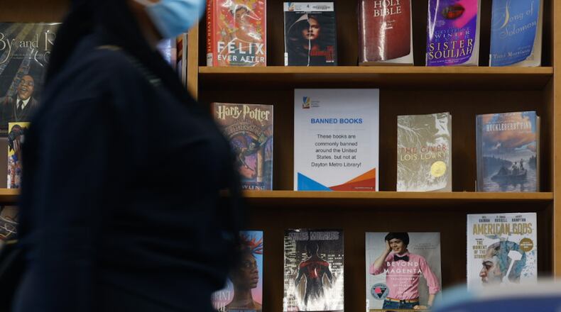 The Trotwood branch of the Dayton Metro Library has a bookshelf displaying the most popular banned books across the country. Trotwood teen librarian Steve Moser said that the most targeted books in 2022 were subjects about LGBTQ+ and Black people. JIM NOELKER/STAFF
