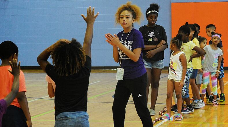 Lohrey Rec Center, summer camp staff member, Nevaeh McDonald, center, prepares camp members for a tug-of-war competition Wednesday, June 8, 2022. MARSHALL GORBY\STAFF