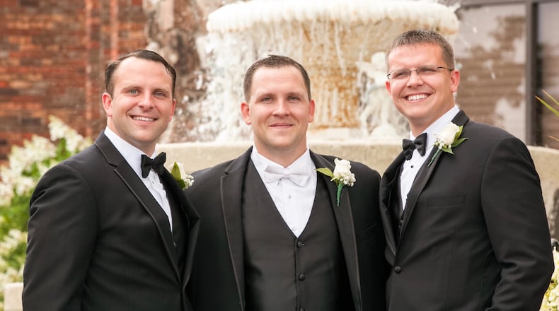 Eric, Andy and Matt Farrell pose for a photo. All three have coached at the University of Dayton. Submitted photo
