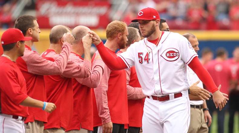 Reds pitcher Rookie Davis is introduced on Opening Day before a game against the Phillies on Monday, April 3, 2017, at Great American Ball Park in Cincinnati. David Jablonski/Staff