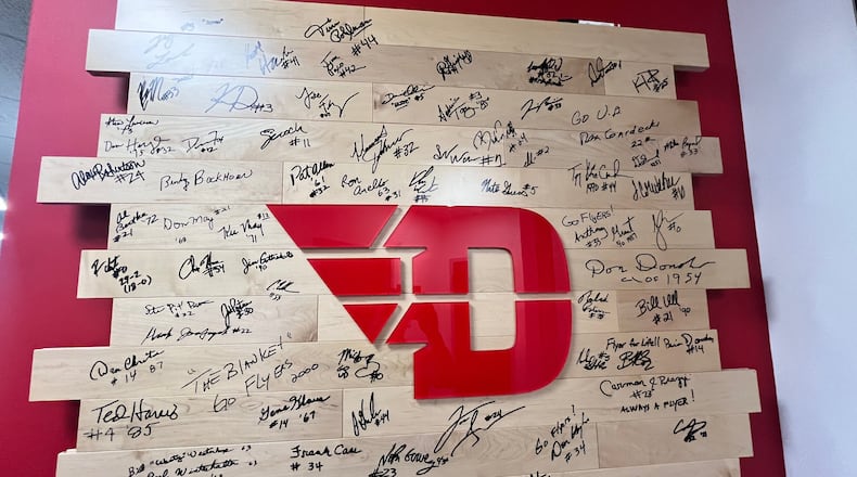 The Dayton basketball alumni board, signed by former players, is located in the coaches' offices at UD's Cronin Center. David Jablonski/Staff