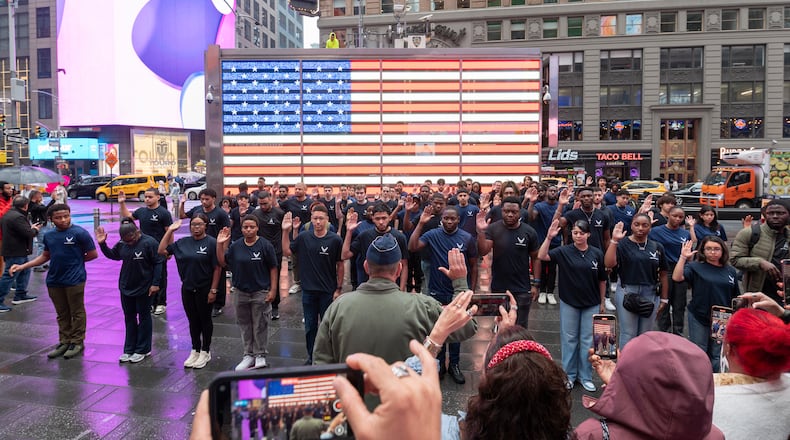 Brig. Gen. Christopher Amrhein, Air Force Accessions Center and Air Force Recruiting Service commander, administers the oath of enlistment to Delayed Entry Program members at a swearing-in ceremony in Times Square, New York, NY, May 16, 2025.  (U.S. Air Force photo by Tech. Sgt. Michael Washburn).