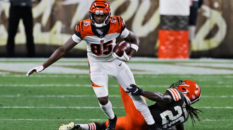 Cincinnati Bengals wide receiver Tee Higgins (85) breaks a tackle from Cleveland Browns cornerback Tavierre Thomas (20) during the second half of an NFL football game Thursday, Sept. 17, 2020, in Cleveland. (AP Photo/Ron Schwane)