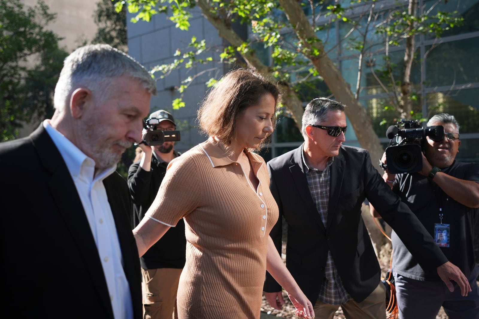 Anamaria Baralt, center, a cousin of Erik and Lyle Menendez, who were convicted of killing their parents in 1989, arrives to court Friday, May 9, 2025, in Los Angeles. (AP Photo/Jae C. Hong)