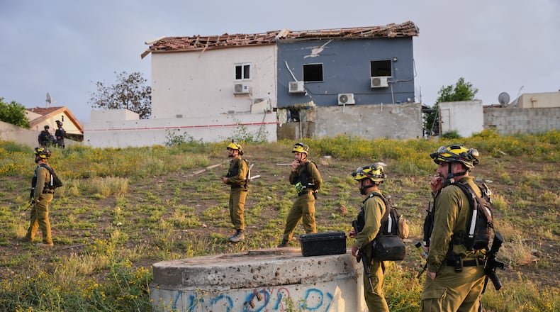 Israeli security forces work at the site of an Iranian missile strike, in Beersheba, southern Israel Sunday, March 29, 2026. (AP Photo/Maya Levin)