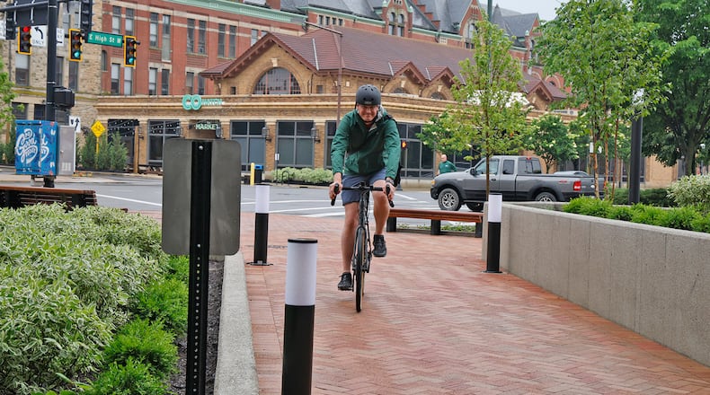 Kevin Rose rides his bike through the City Hall Plaza for the Bike to Work Day event Friday, May 17, 2024. The weather didn't cooperate, but several die-hard cyclists made the ride in the rain for the Bike to Work Day Springfield event. BILL LACKEY/STAFF