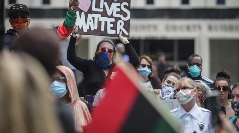 A large group of protesters, some with and some without masks, protested near the Federal Building in downtown Dayton last weekend. Large groups of people crowd together in closed quarters during these protest. JIM NOELKER/STAFF