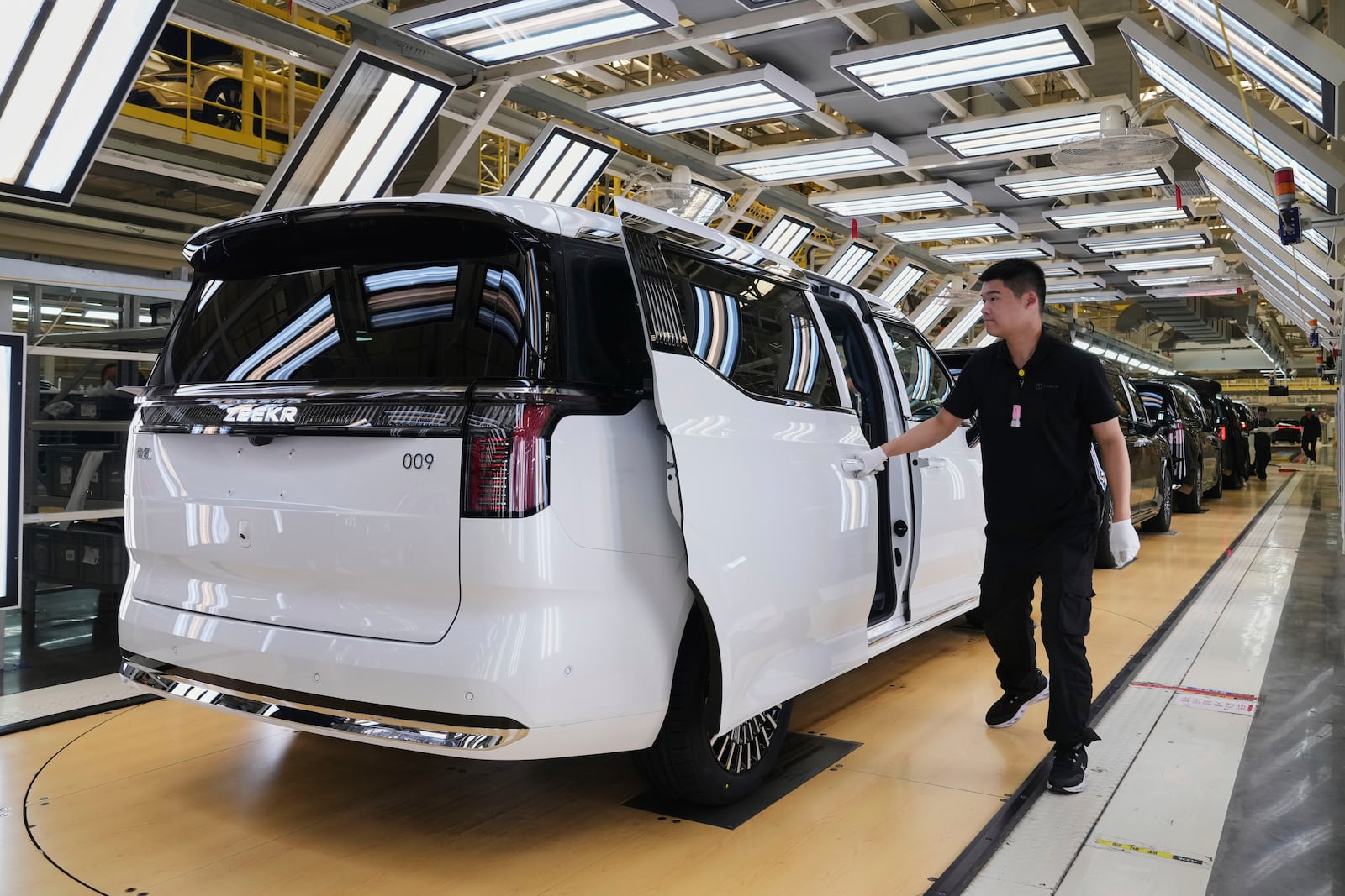 A worker gives a final check on Zeekr EV models at the Chinese automaker Zeekr assembly plant, in Ningbo, east China's Zhejiang Province on April 16, 2025. (AP Photo/Andy Wong)