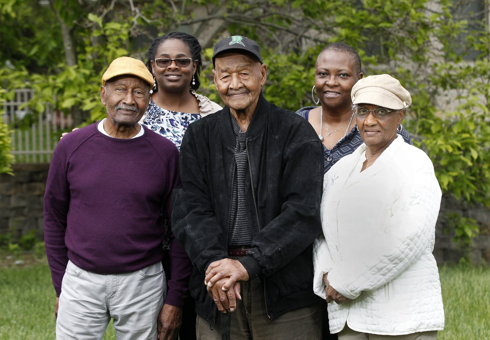 Nathaniel Lee Scott of Dayton celebrated his 100th birthday in March. Scott will throw out the first pitch at an upcoming Dayton Dragons game. He is pictured with his brother Lloyd Scott (left) and sister Dolores Stallings (right), a cousin, Jeri Dokes (left rear) and niece Annie Williams (right rear). LISA POWELL / STAFF