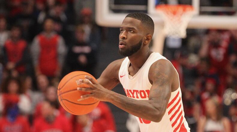 Dayton’s Jalen Crutcher passes the ball against Cedarville in an exhibition game on Saturday, Nov. 2, 2019, at UD Arena. David Jablonski/Staff
