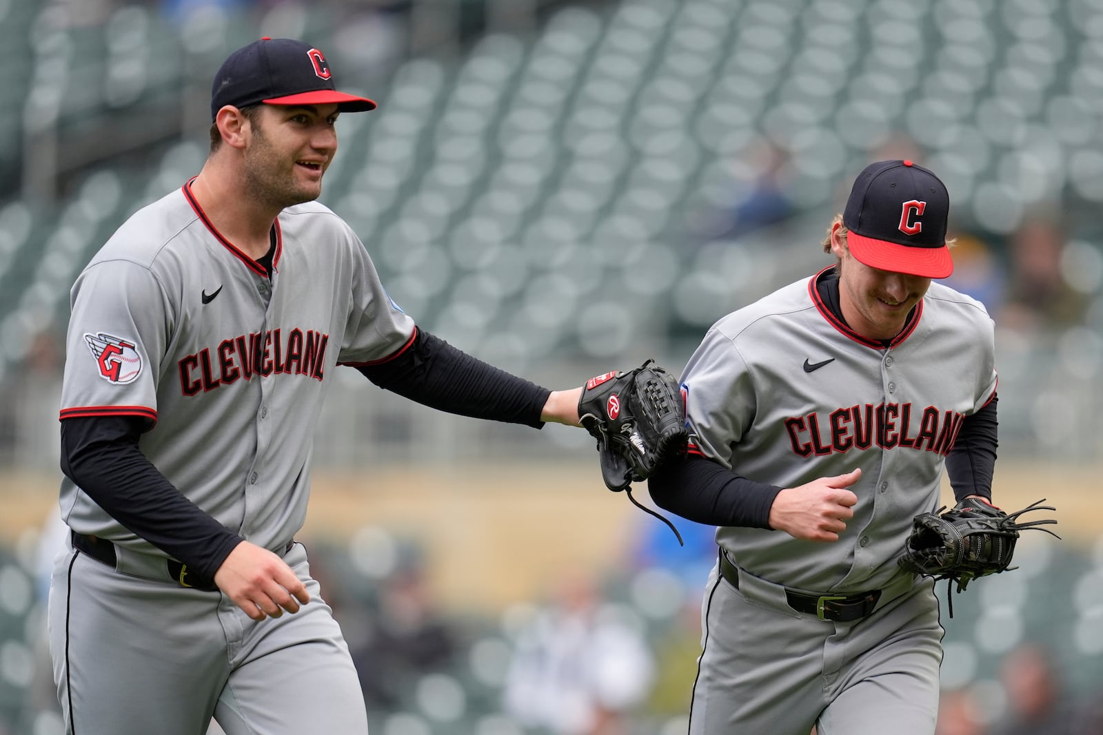 Cleveland Guardians starting pitcher Gavin Williams, left, pats first baseman Kyle Manzardo (9) after catching a pop-out to first hit by Minnesota Twins' Royce Lewis to end the bottom of the first inning in the second baseball game of a doubleheader Wednesday, May 21, 2025, in Minneapolis. (AP Photo/Abbie Parr)