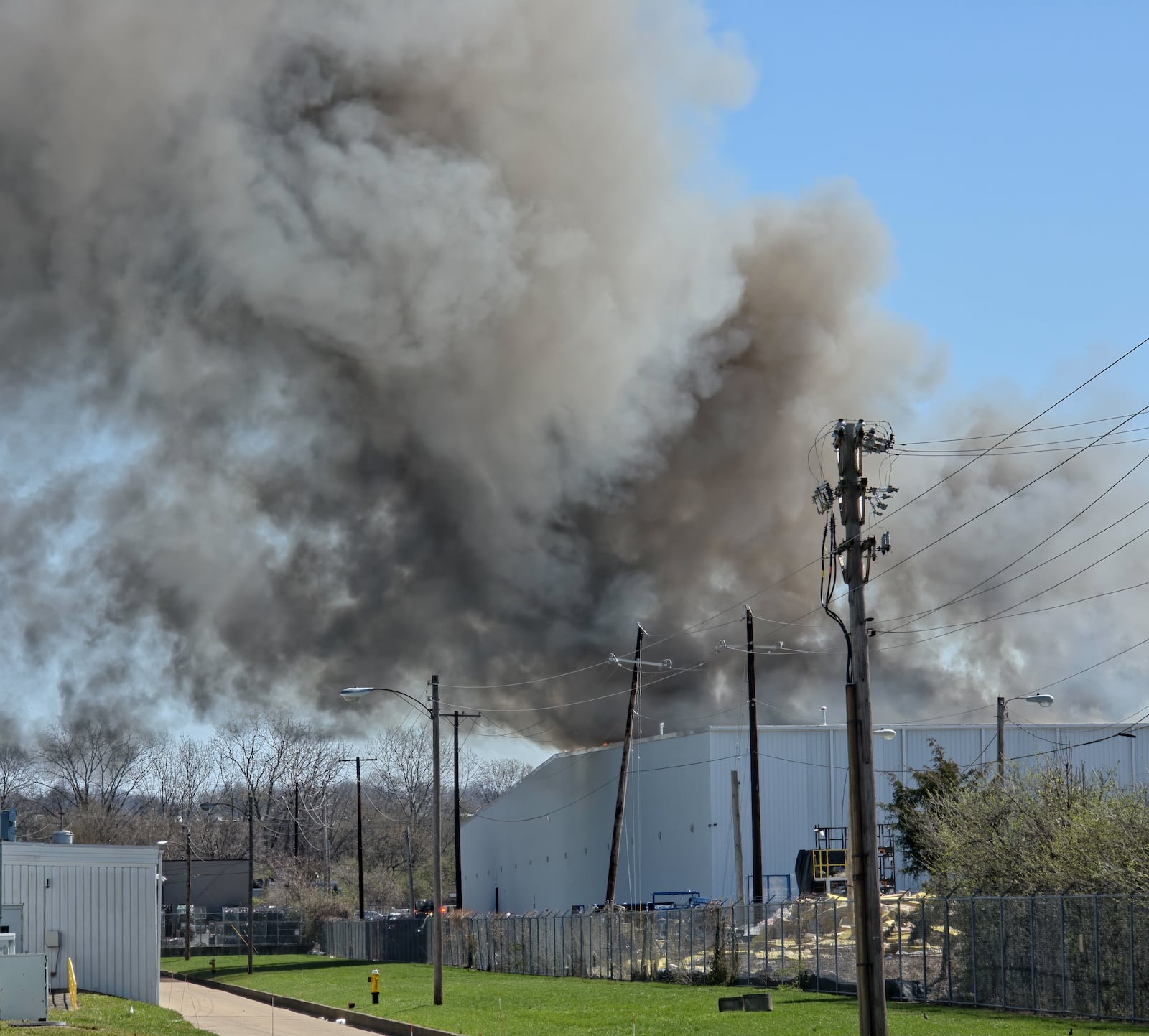 The fire at Fuyao Glass America rekindled shortly before noon on Tuesday, March 24. While firefighters have been working at the site since it first caught fire Sunday night, they had been focusing on hotspots before a large rekindling caused black smoke to rise that was visible for miles. The building that caught fire was Fuyao's coating facility, which was still in the finishing stages of construction. BRYANT BILLING / STAFF