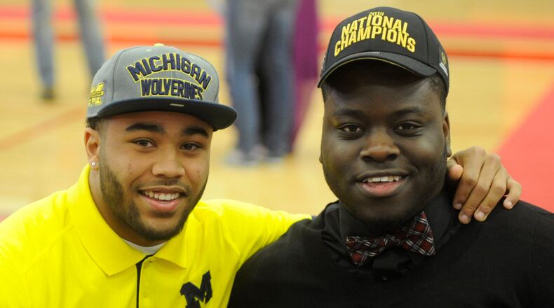 Wayne High School teammates Tyree Kinnel (left, University of Michigan) and Robert Landers (Ohio State) during National Signing Day ceremony at the school on Wednesday, Feb. 4, 2015. MARC PENDLETON / STAFF