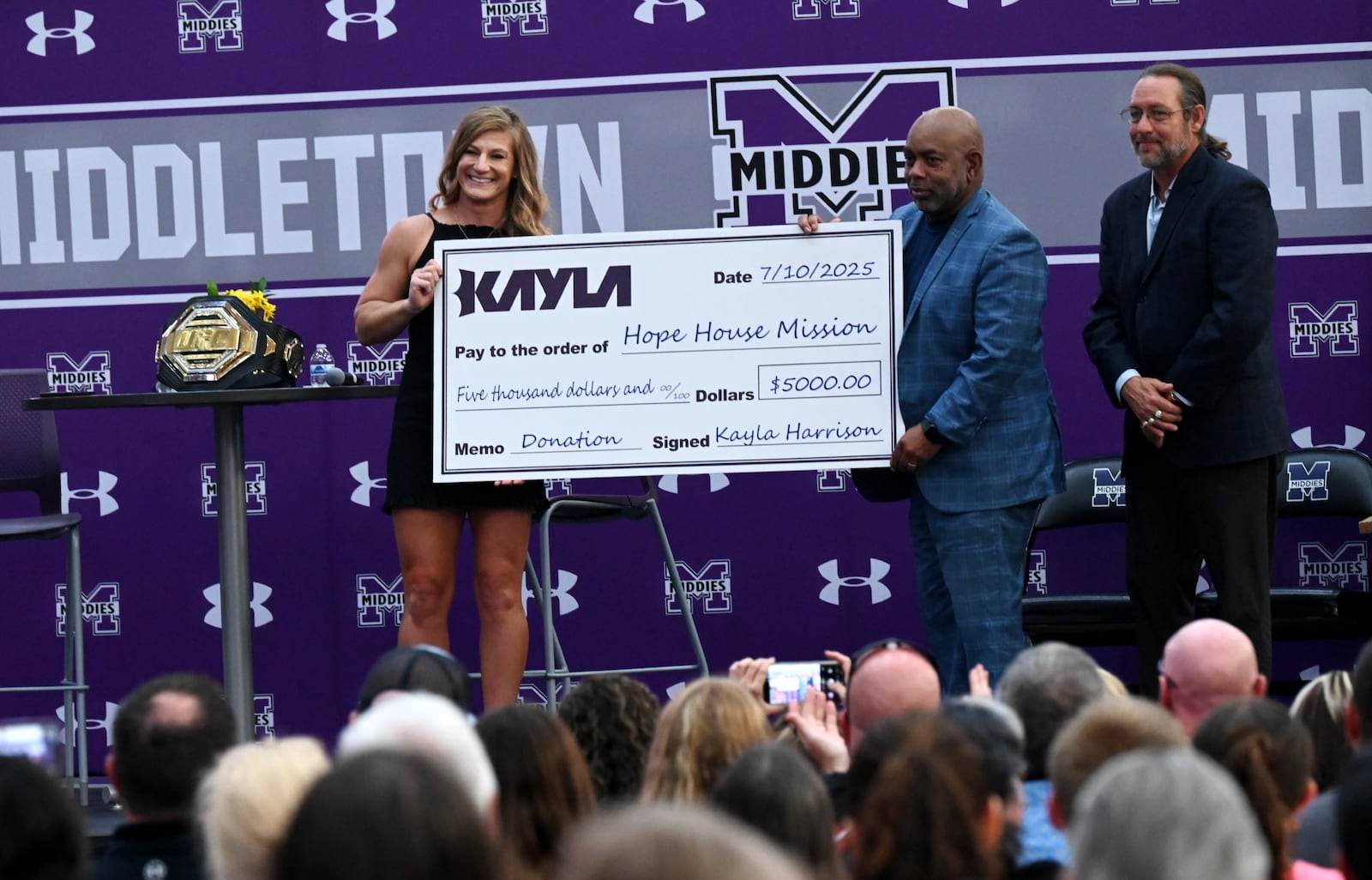 Middletown native and recently crowned UFC Women's Bantamweight Champion Kayla Harrison returned to her hometown  on Thursday, July 10, 2025. She spoke an estimated 2,000 that attended Wade E. Miller gym at Middletown High School where she donated $5,000 to Hope House Mission and received a key to the city. MICHAEL D. PITMAN/STAFF