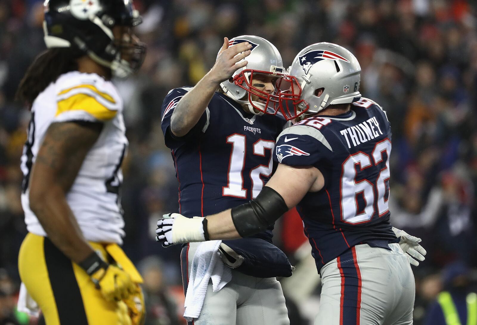 FOXBORO, MA - JANUARY 22: Tom Brady #12 reacts with Joe Thuney #62 of the New England Patriots against the Pittsburgh Steelers in the AFC Championship Game at Gillette Stadium on January 22, 2017 in Foxboro, Massachusetts. (Photo by Elsa/Getty Images)