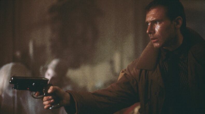 'Blade runner' Rick Deckard (Harrison Ford) enters Sebastian's apartment, where he is soon to be attacked by the replicant Pris (Daryl Hannah, immediately behind Deckard's gun), in a scene from Ridley Scott's futuristic thriller 'Blade Runner', 1982. (Photo by Warner Bros./Archive Photos/Getty Images)