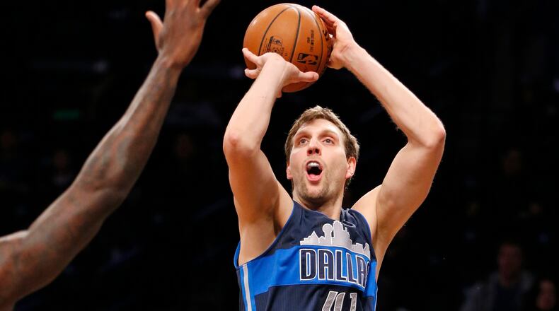 FILE - In this March 19, 2017, file photo, Dallas Mavericks forward Dirk Nowitzki (41) shoots against the Brooklyn Nets in the first half of an NBA basketball game, in New York. Nowitzki, the career scoring leader among international players, will be one of the captains for the NBAs Africa Game on Aug. 5. (AP Photo/Kathy Willens, File)